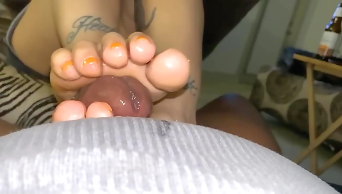 Tattooed guy getting a footjob on his feet on a camera