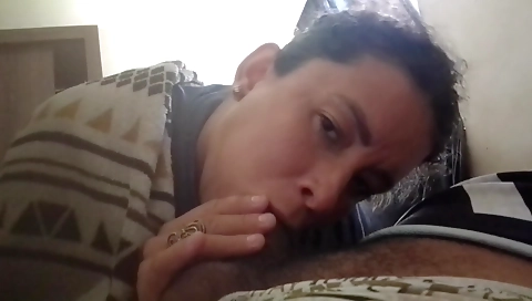 Ebony brunette in a black dress gives a big cock deepthroat