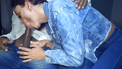 Latina in red top riding with her boyfriend in a car