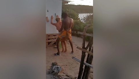 A milf gets fucked by an african tribe man in public